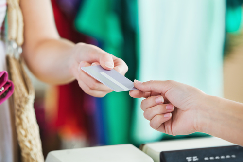 Close-up of a woman paying with her credit card