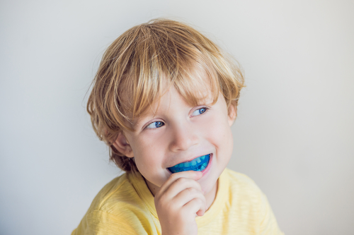 child smiling with mouthguard on