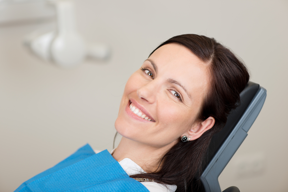 female patient smiling at dentist office