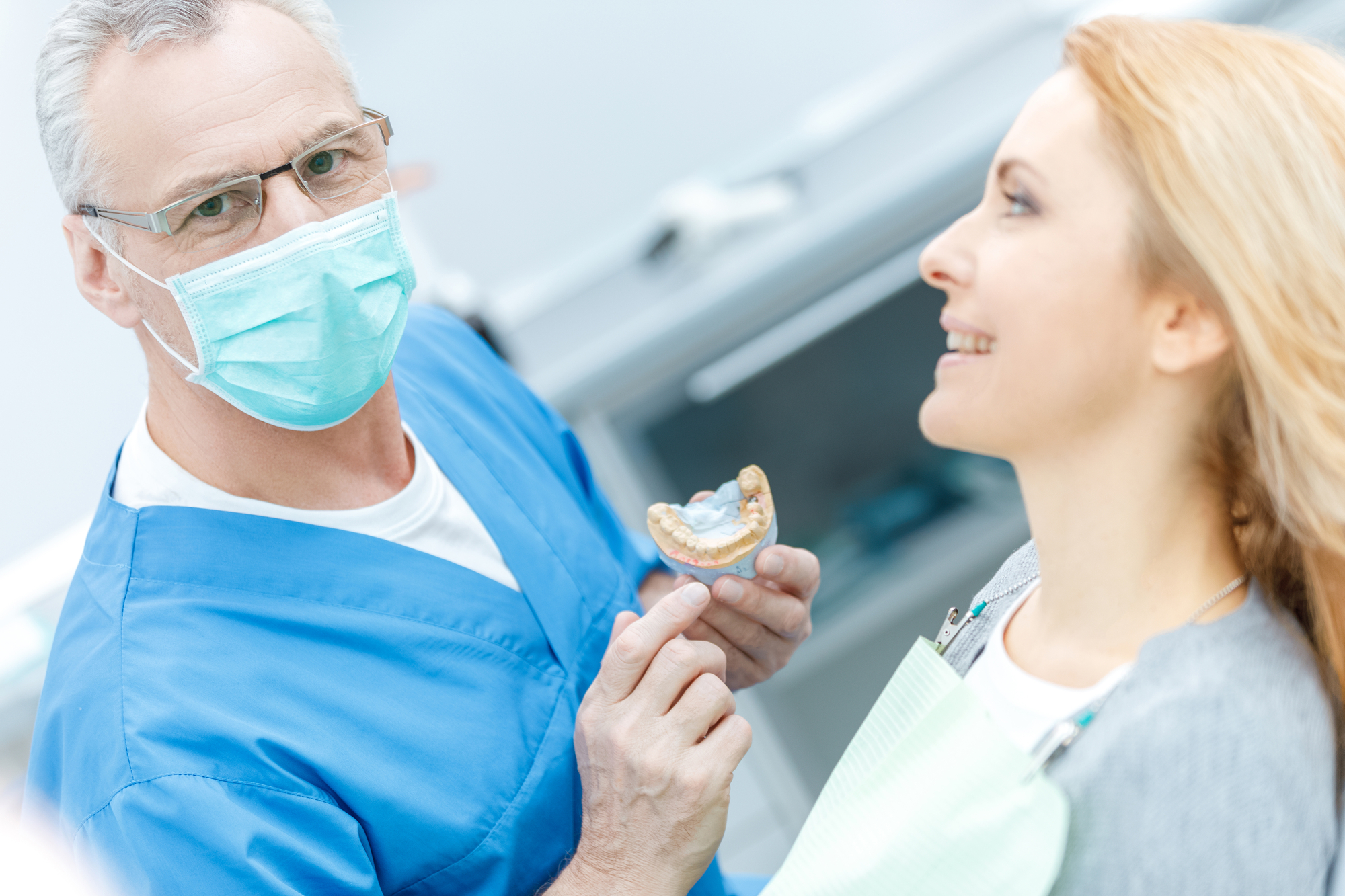 Dentist explaining procedure to patient.