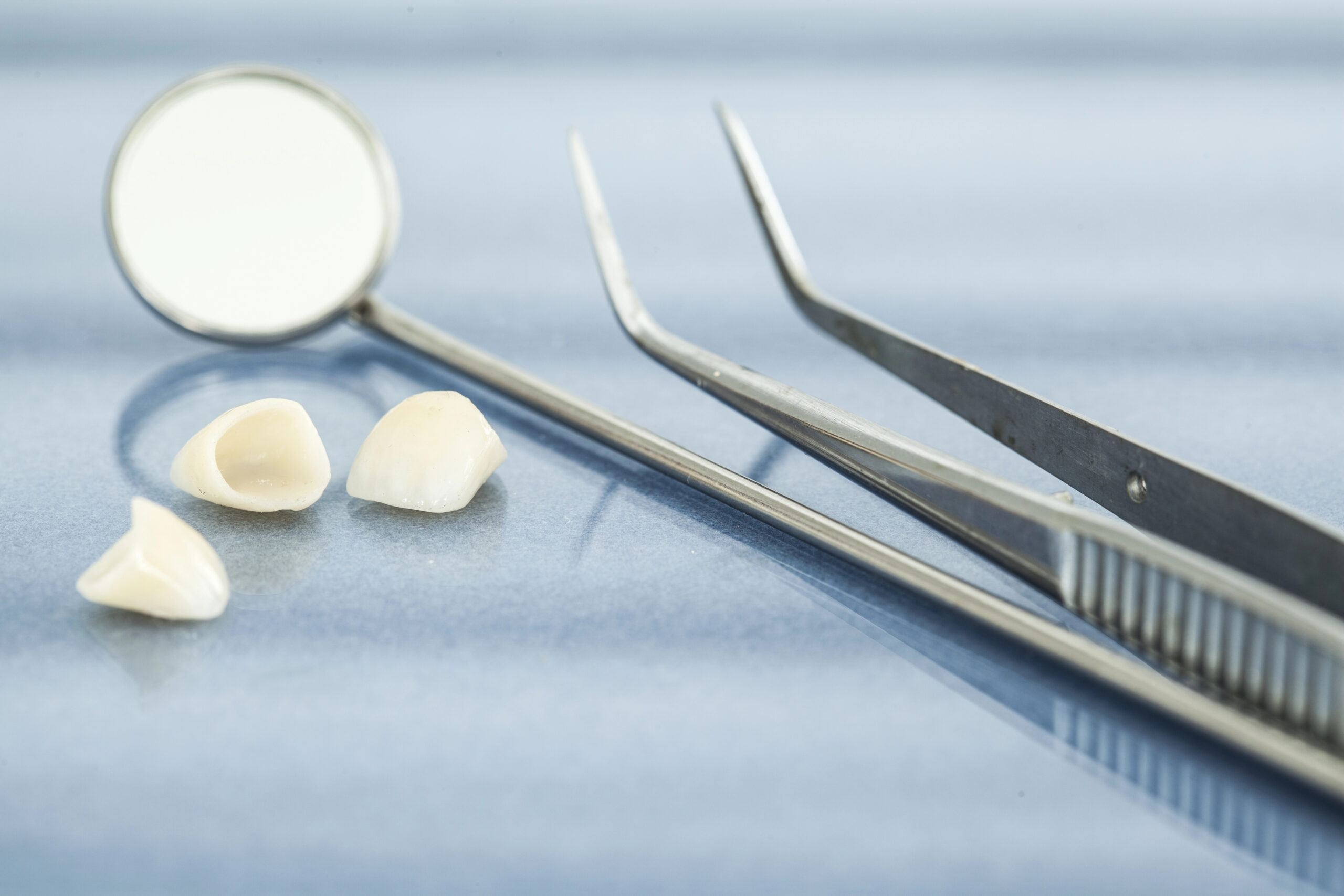 Close up of dental crowns and dentist tools
