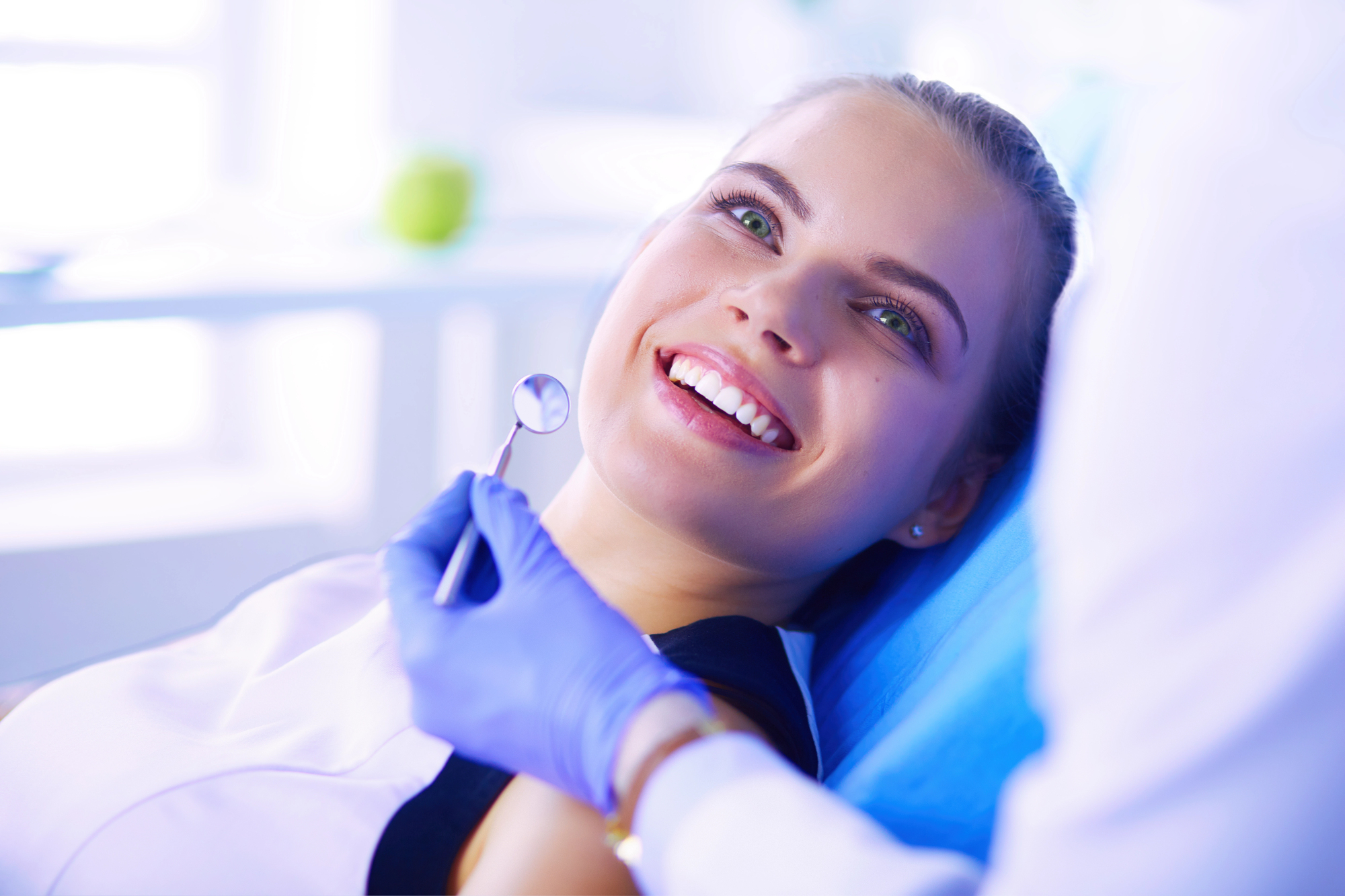 Young woman smiling at dentist. 