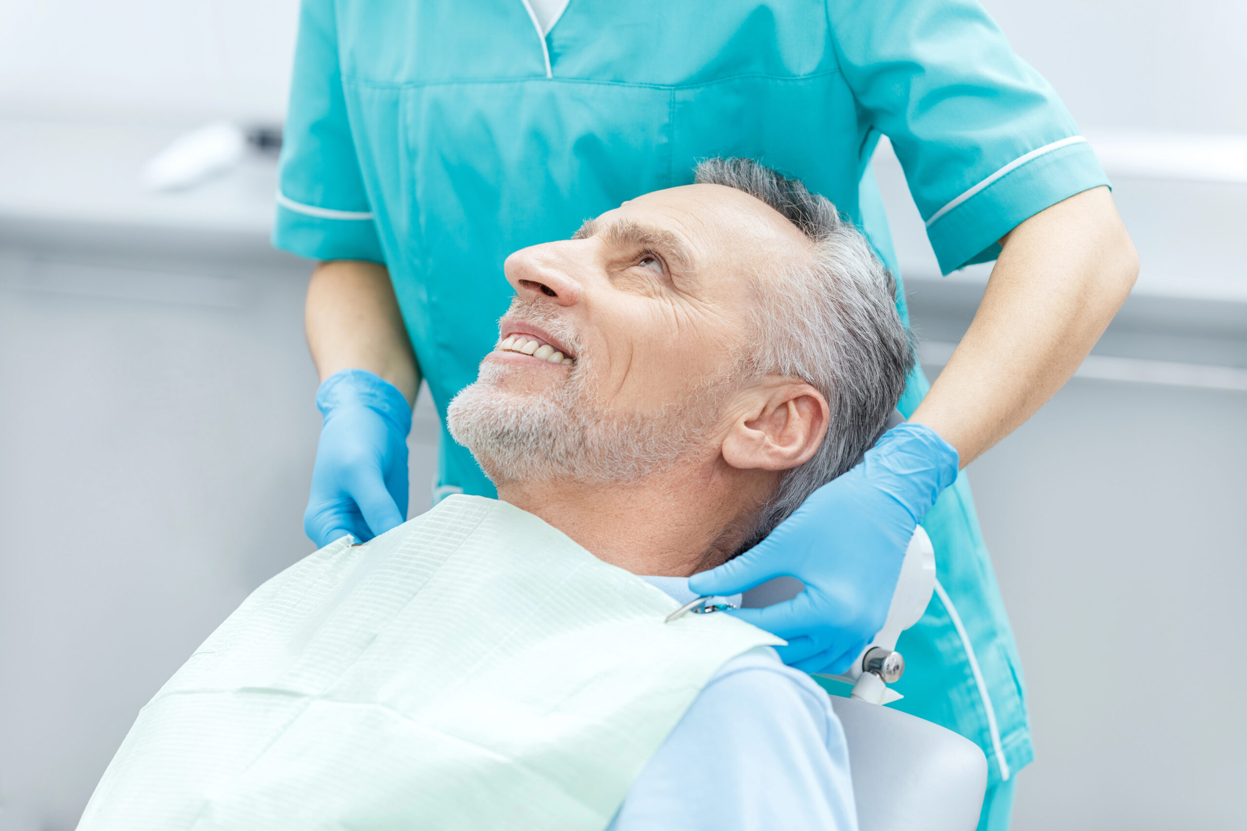 Man smiling in dental chair at regular dental checkup