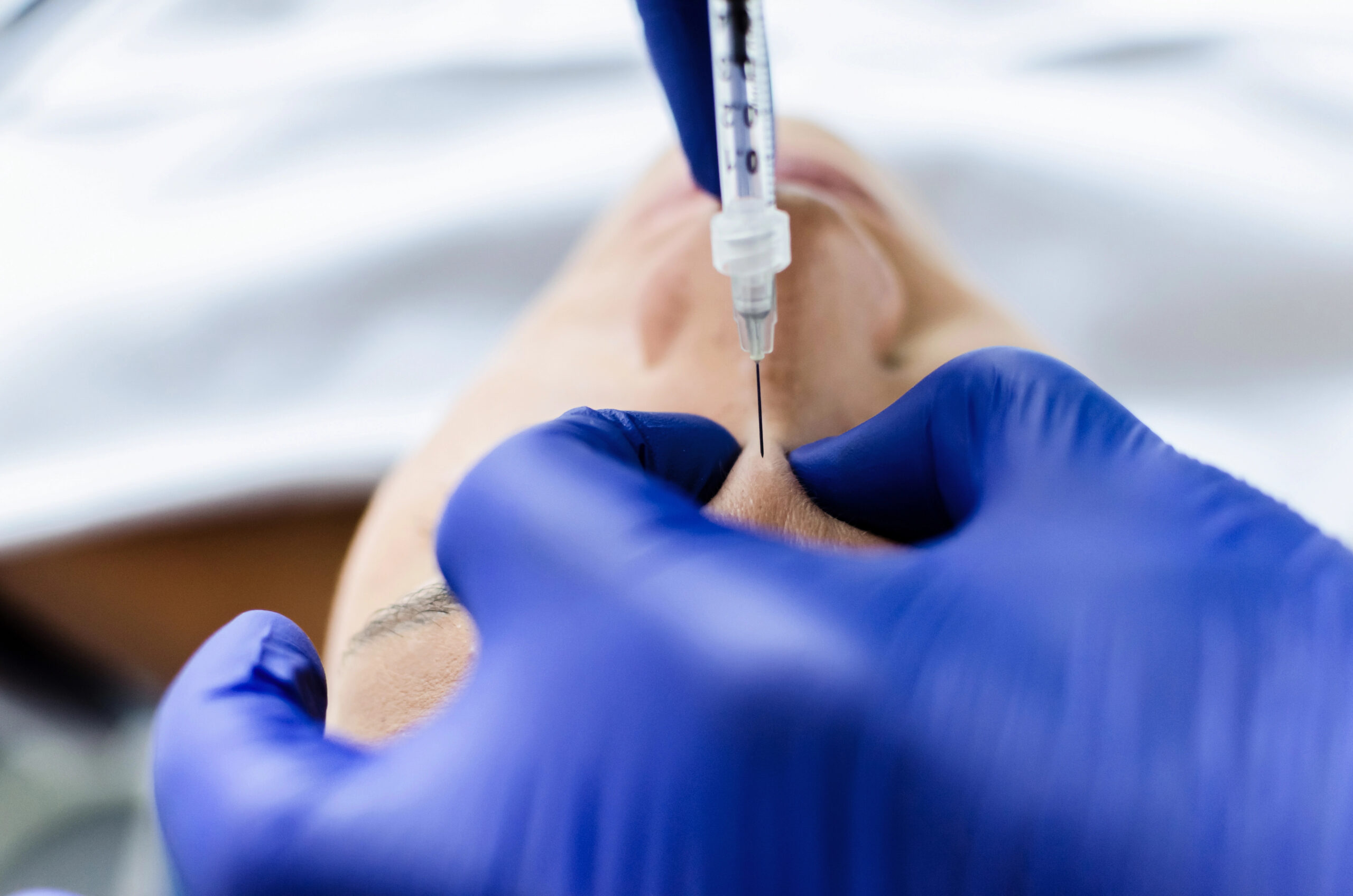 Close up of dentist giving Botox injection. 
